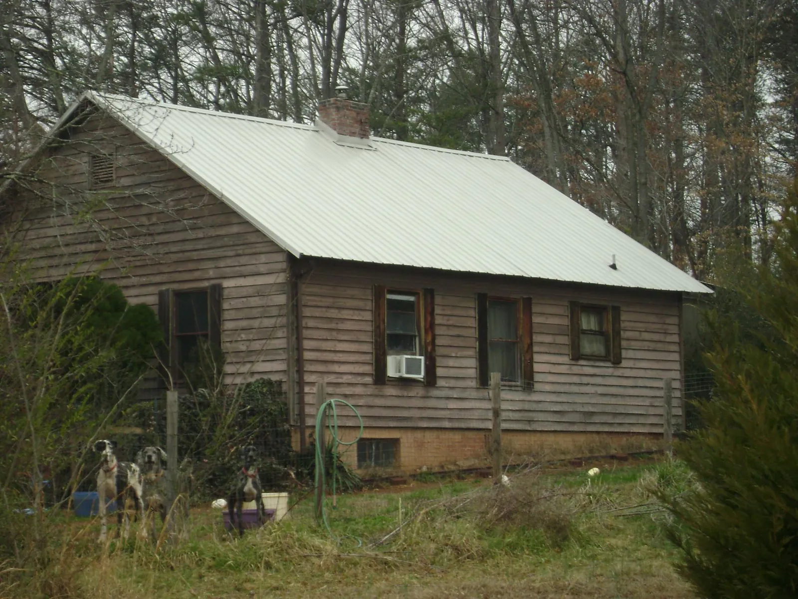 White metal roof on an old wood sided farmhouse, from a Asphalt Shingle Roof Repair job in Saylorsburg